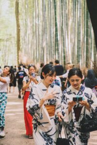 women in traditional clothing walking in forest